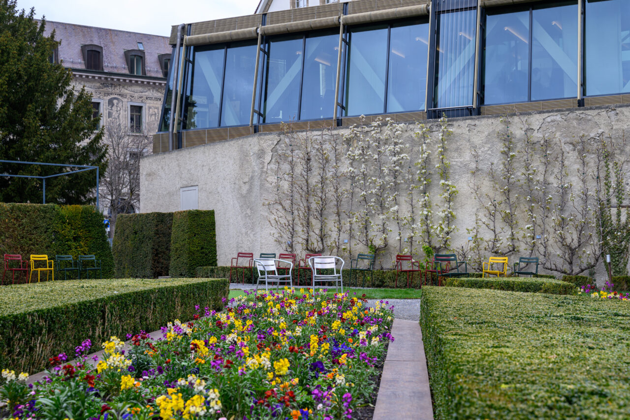 Bunte Blumen und Stühle im Garten